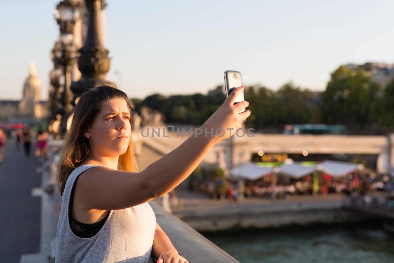 Lucky woman in Paris taking a selfie to post on social networks