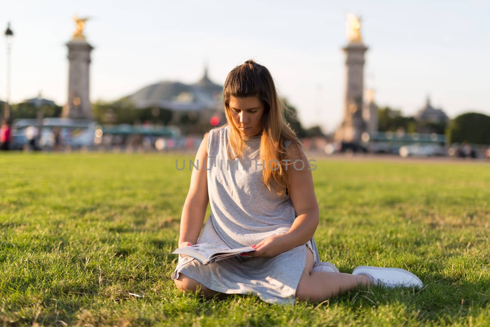 Lucky girl relaxing in the gardens next to the Invalides and the Alexander the 3rd bridge in Paris