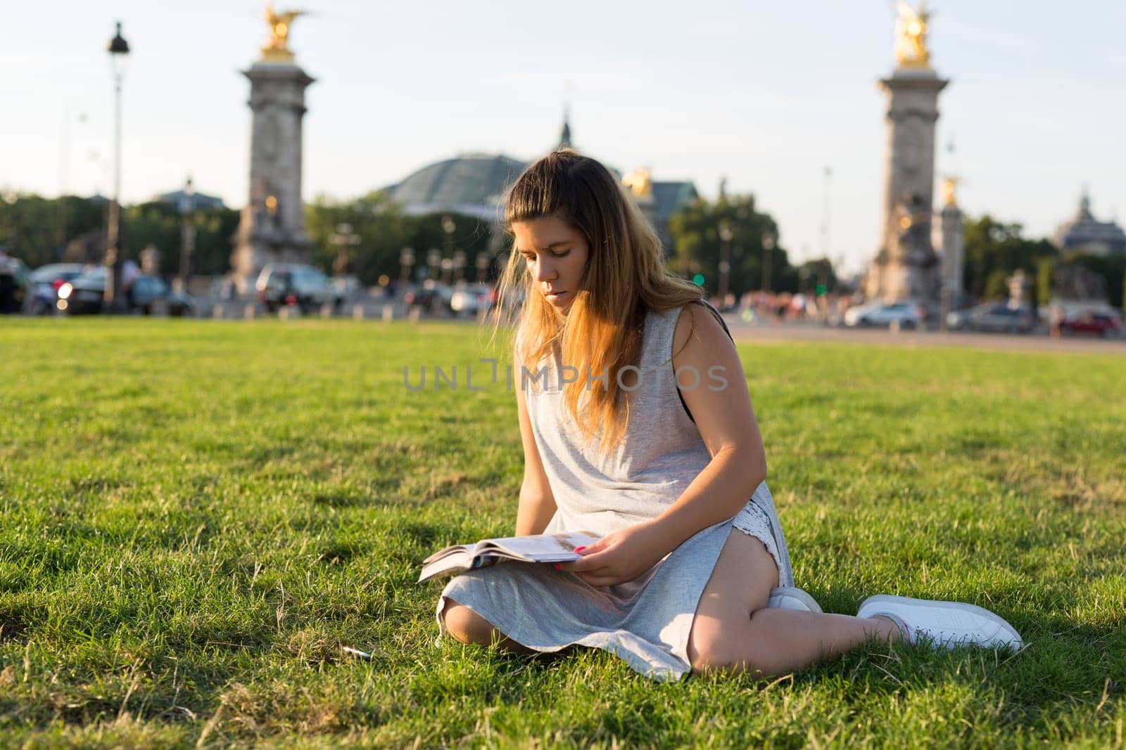 Lucky girl relaxing in the gardens next to the Invalides and the Alexander the 3rd bridge in Paris