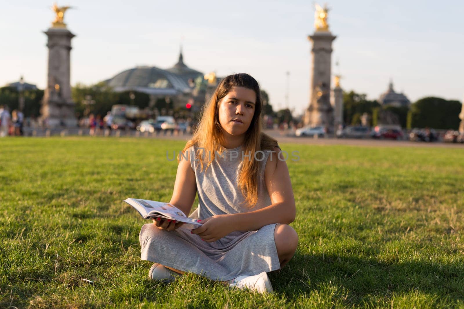 Lucky girl relaxing in the gardens next to the Invalides and the Alexander the 3rd bridge in Paris