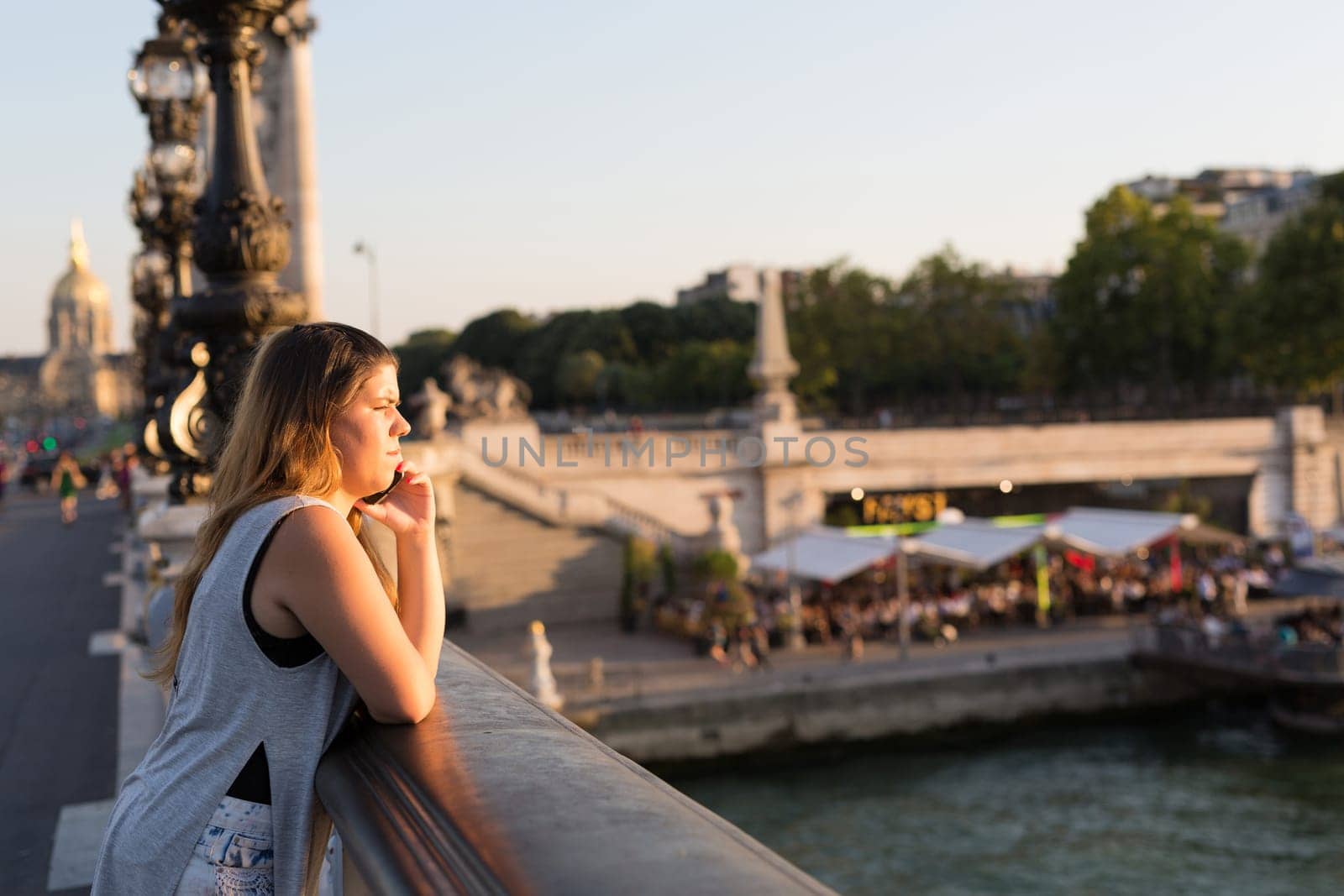 Young woman on vacations in Paris, relaxing over the Alexander the 3rd bridge