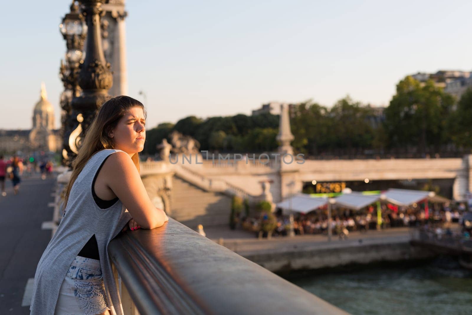 Young woman on vacations in Paris, relaxing over the Alexander the 3rd bridge
