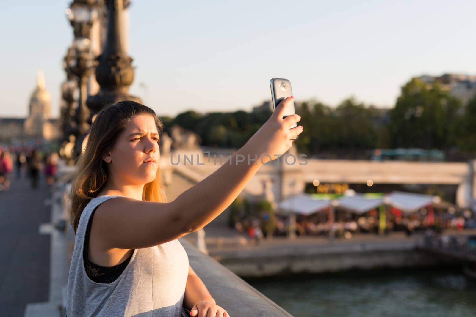 Lucky woman in Paris taking a selfie to post on social networks