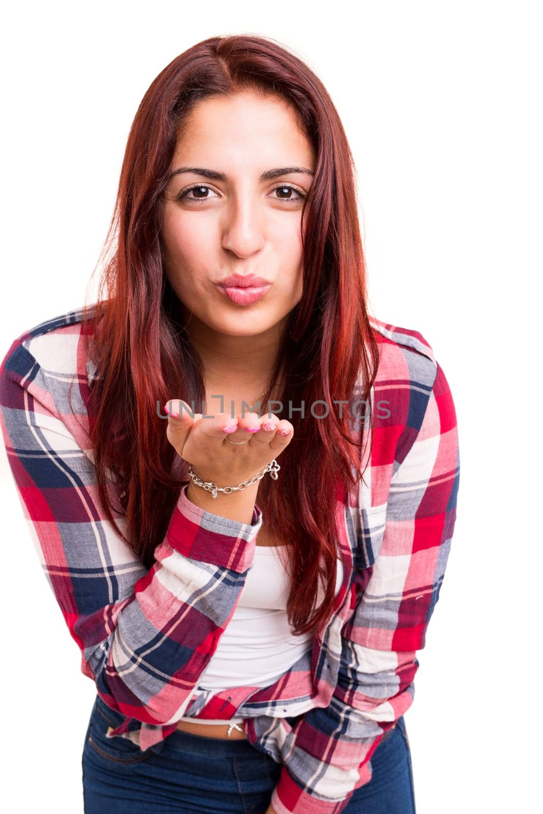 Beautiful young woman blowing you a kiss, isolated over white