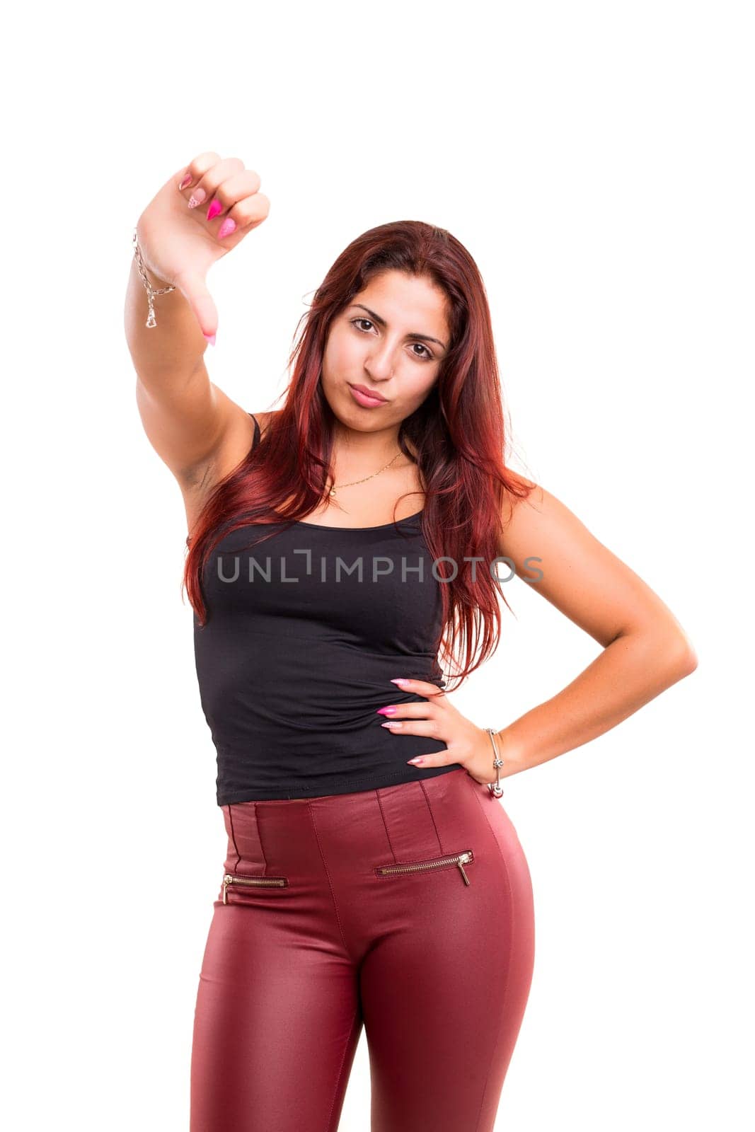 Studio shot of a young woman signaling thumbs down