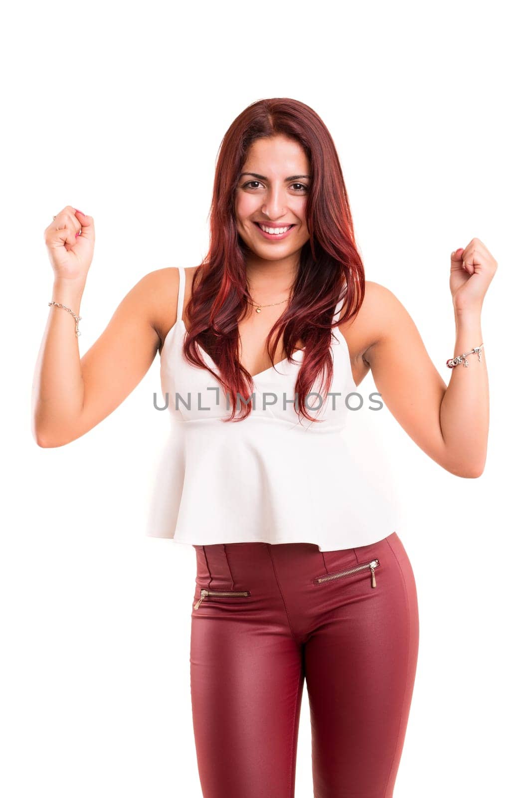 Studio shot: Happy woman with raised arms
