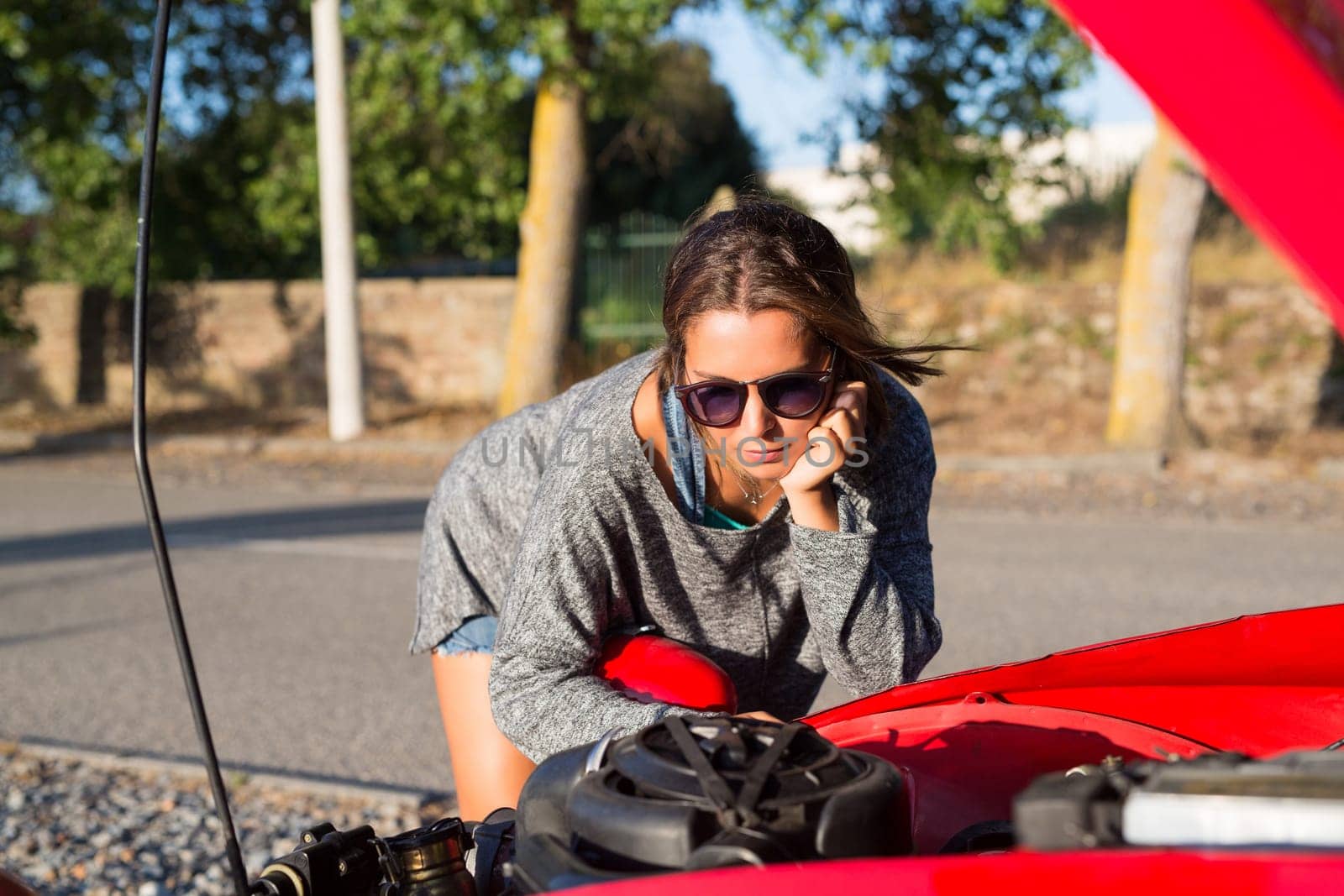 Woman on a roadtrip having a problem with her old car