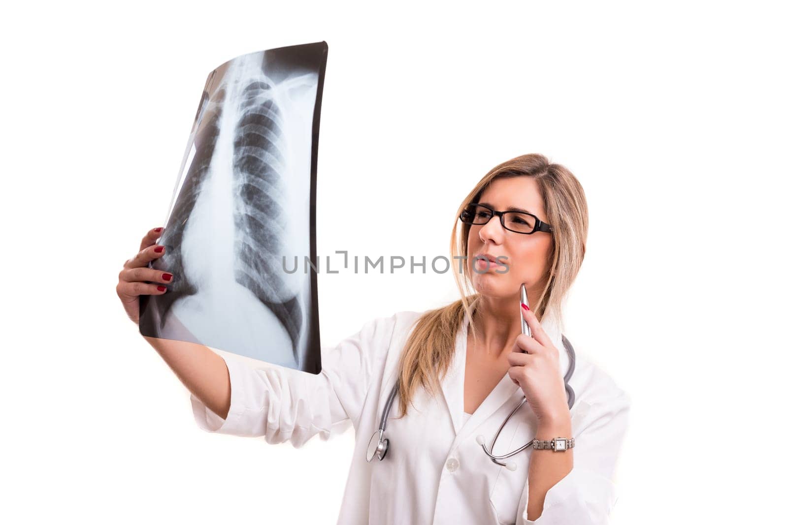 Beautiful young doctor looking at some exams, isolated over white