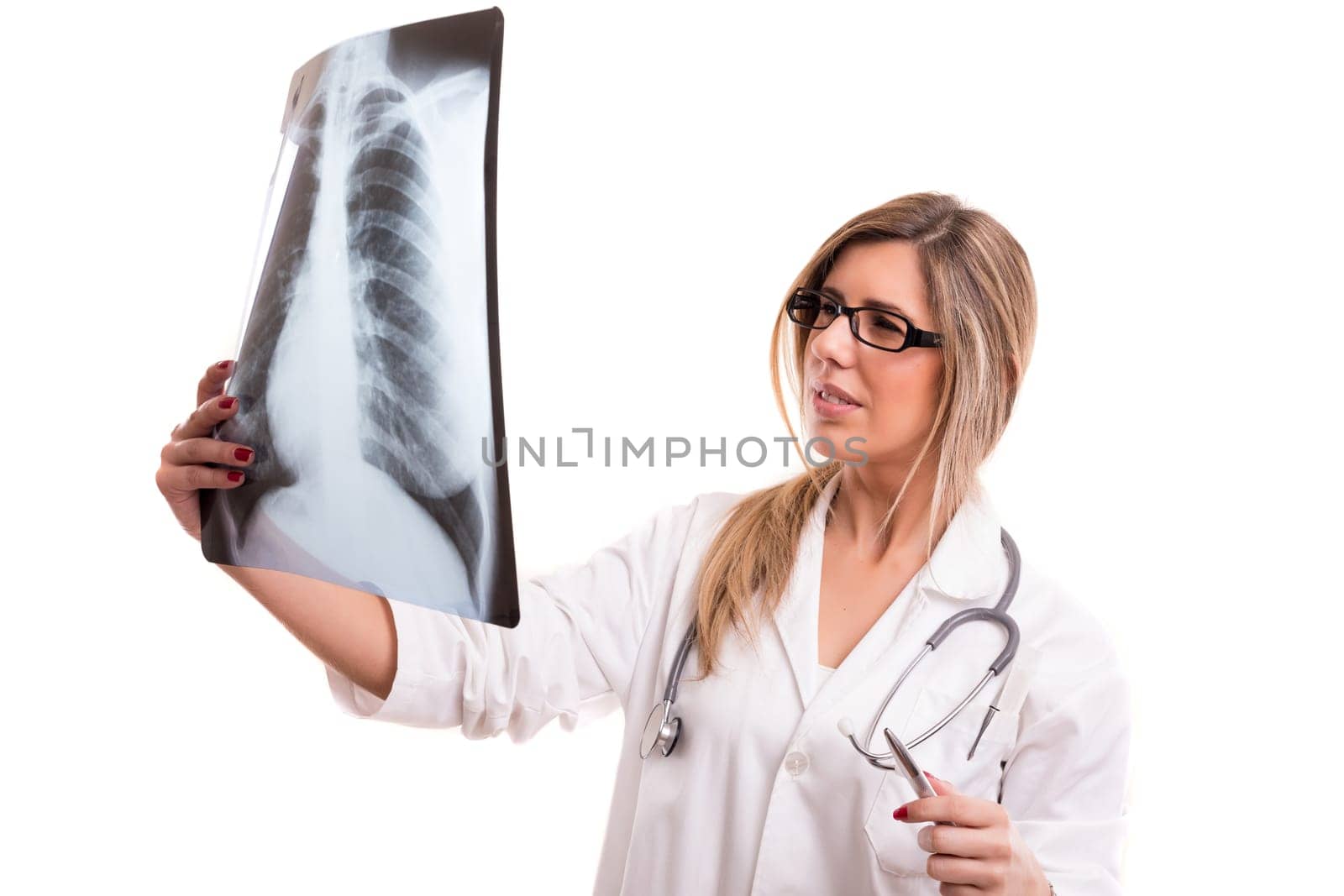 Beautiful young doctor looking at some exams, isolated over white
