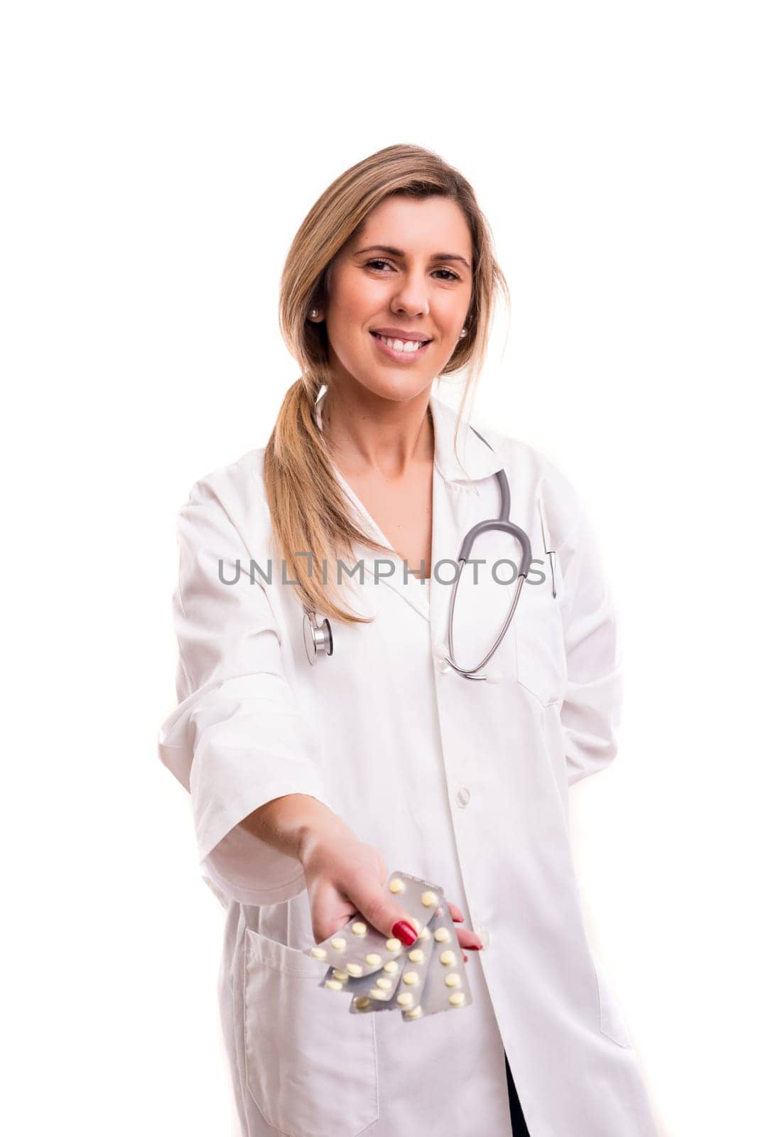 Medic holding some pills, isolated over white