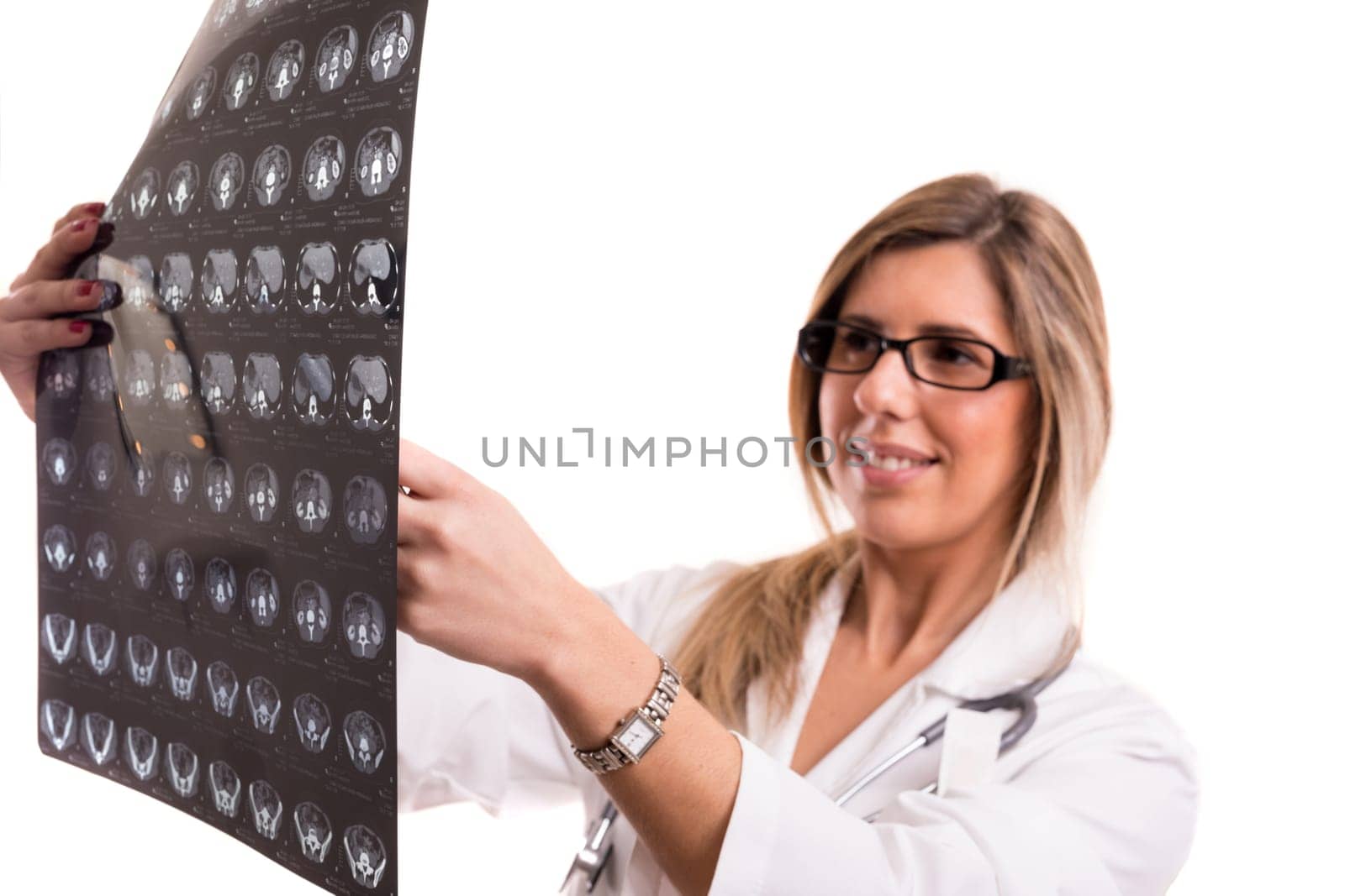 Beautiful young doctor looking at some exams, isolated over white