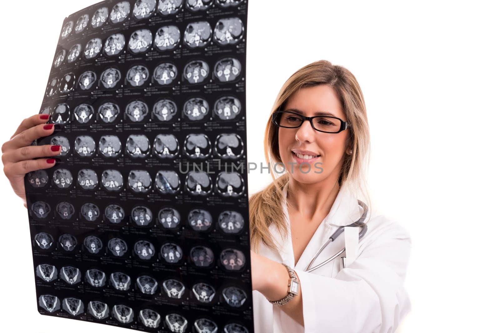 Beautiful young doctor looking at some exams, isolated over white