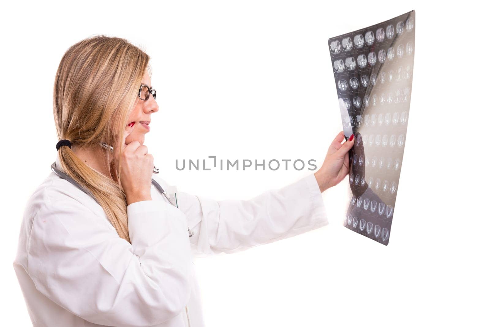 Beautiful young doctor looking at some exams, isolated over white