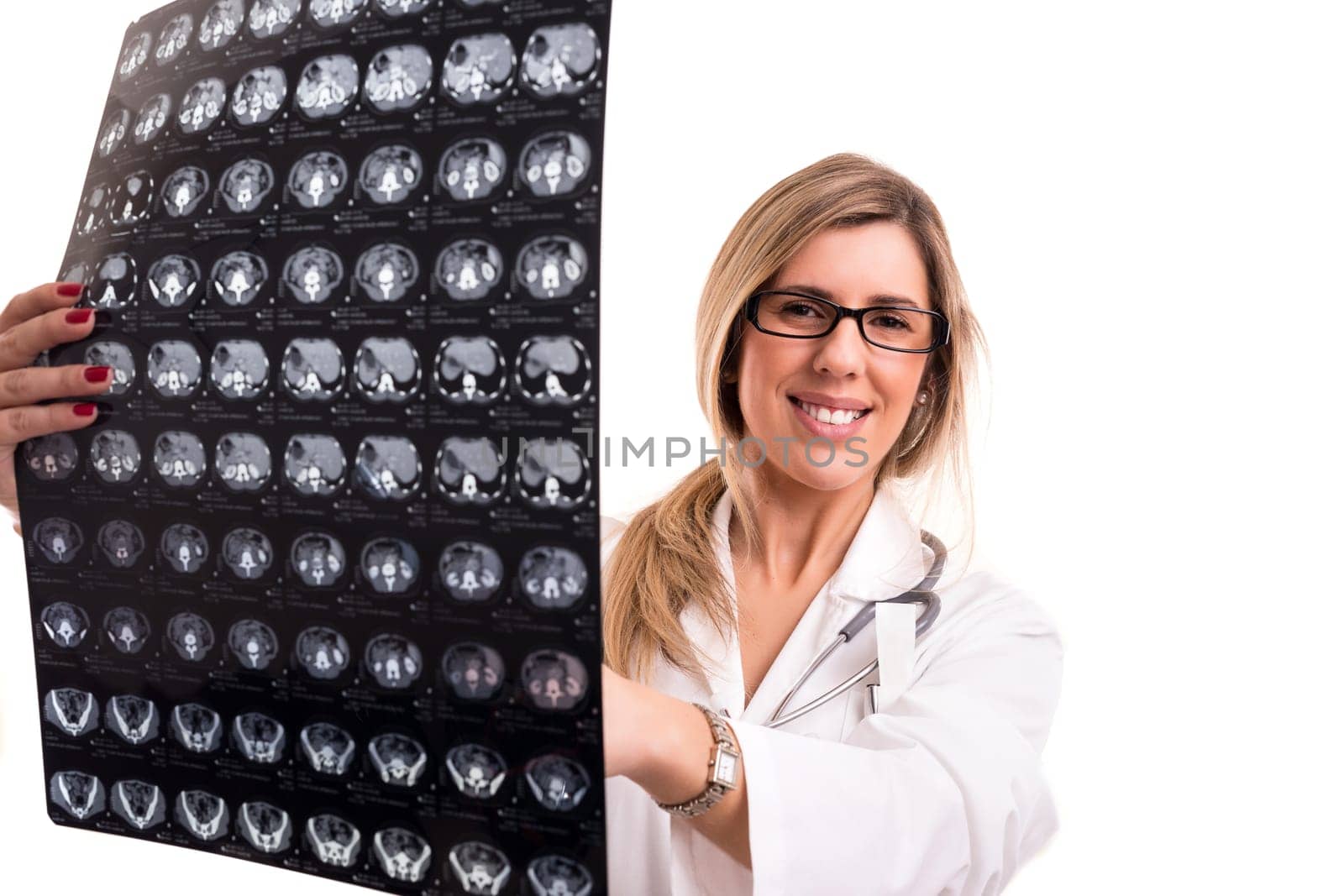 Beautiful young doctor looking at some exams, isolated over white