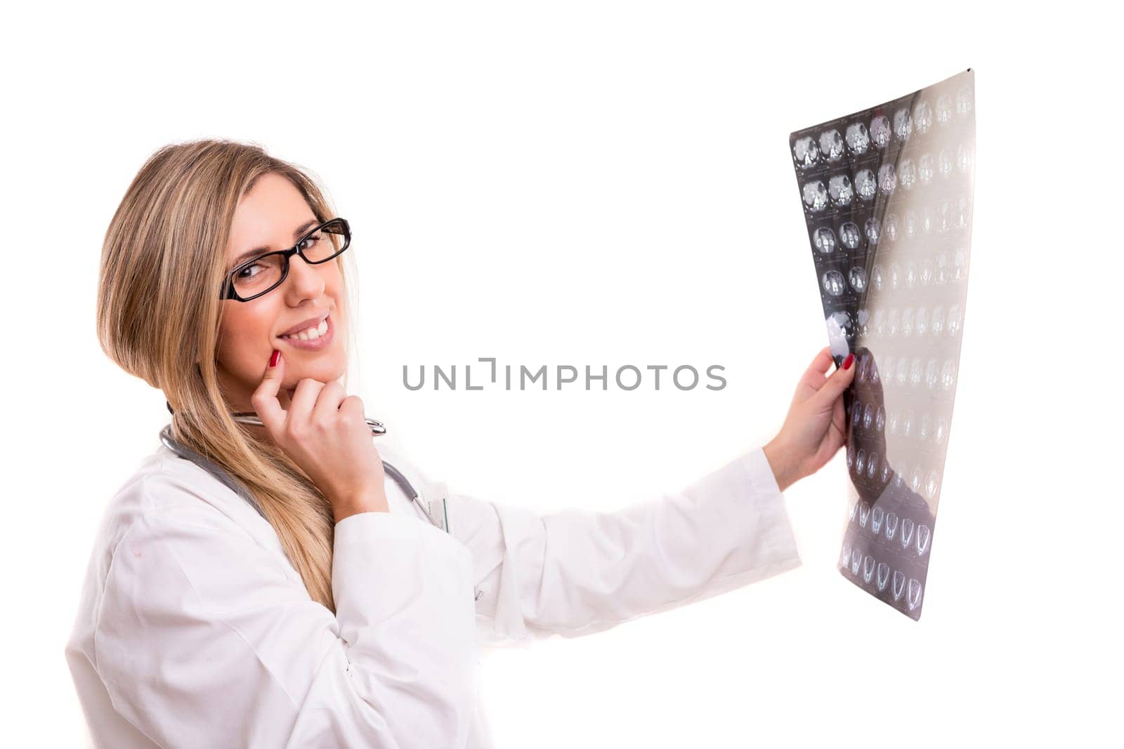 Beautiful young doctor looking at some exams, isolated over white