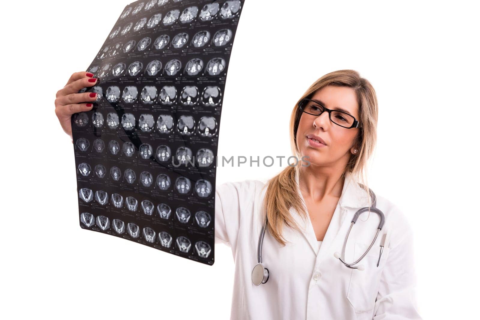 Beautiful young doctor looking at some exams, isolated over white