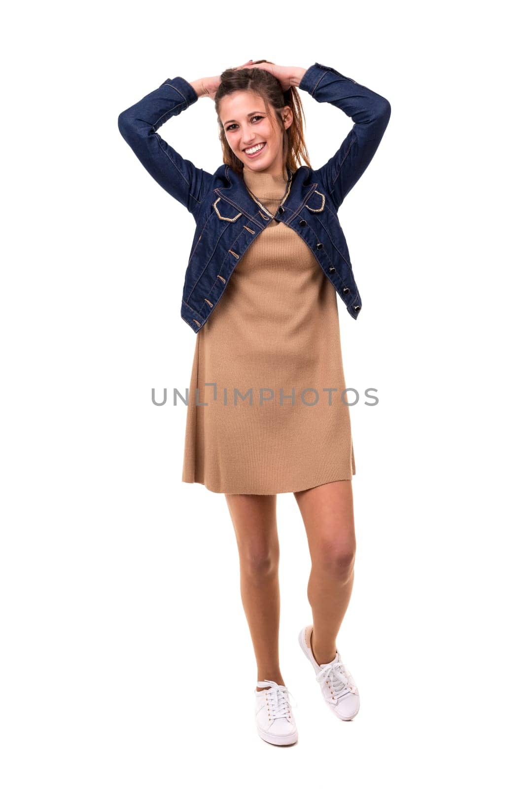 Studio shot: Happy woman with raised arms
