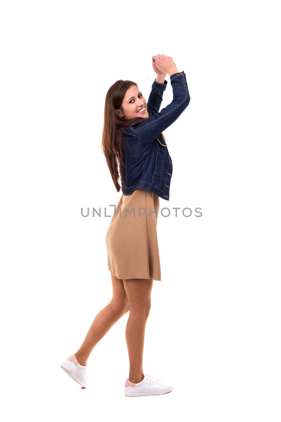 Studio shot: Happy woman with raised arms