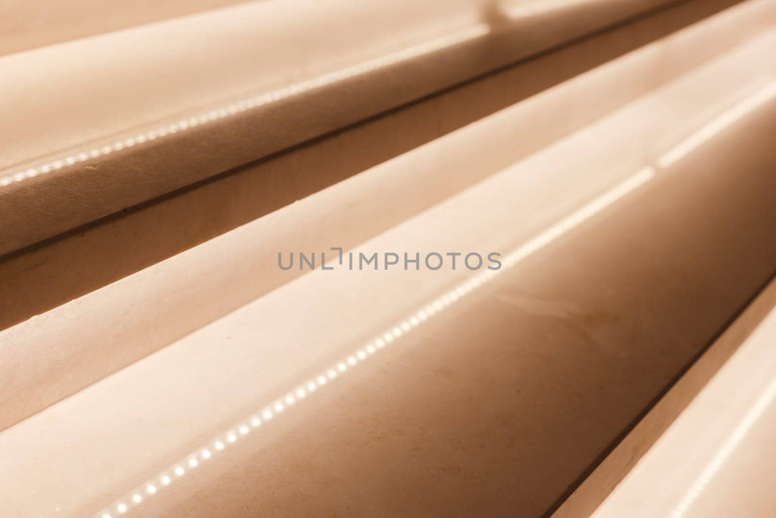 LED illumination of steps of a marble staircase, close up view.