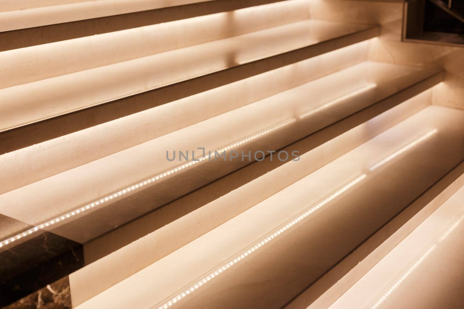 LED illumination of steps of a marble staircase, close up view.
