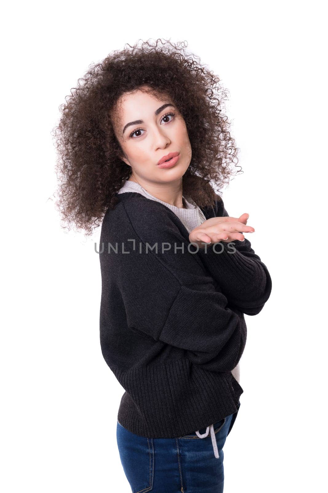 Beautiful young woman blowing you a kiss, isolated over white