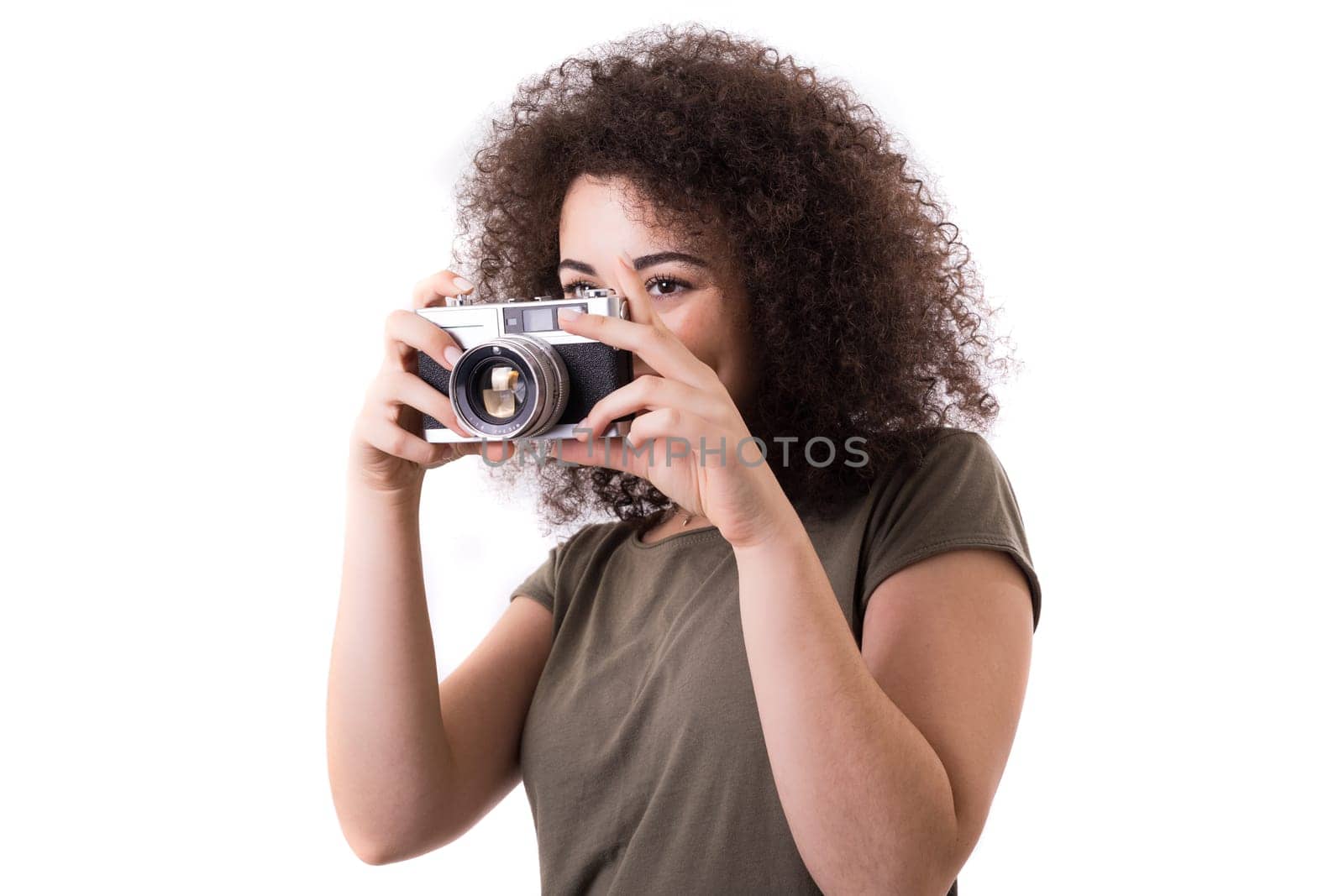 Beautiful woman holding a vintage camera, isolated over white background