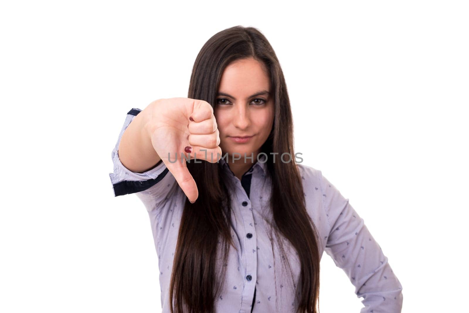 Studio shot of a young woman signaling thumbs down