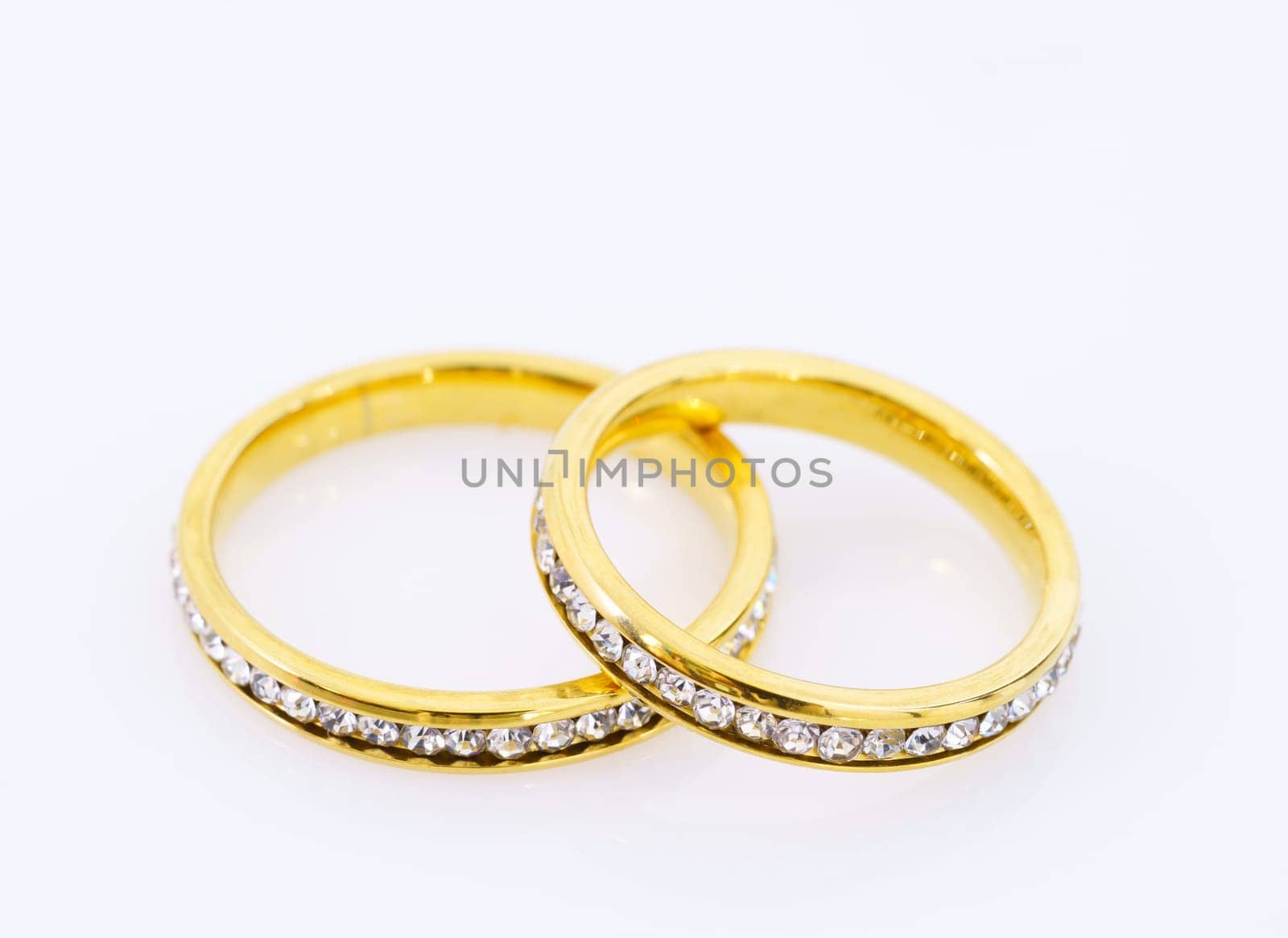 Close up two golden wedding rings  on white background