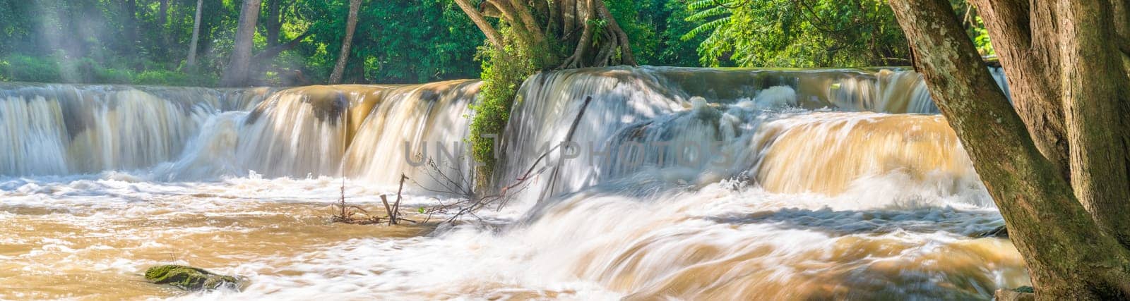 Water falls in tropical rainforest with rock and tree.  Namtok chet saonoi National Park in Thailand