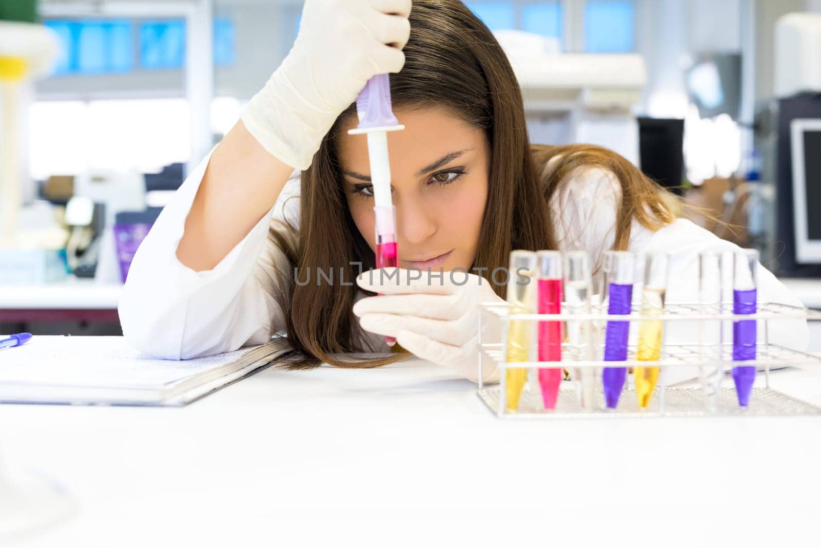 Beautiful young scientist working at the laboratory