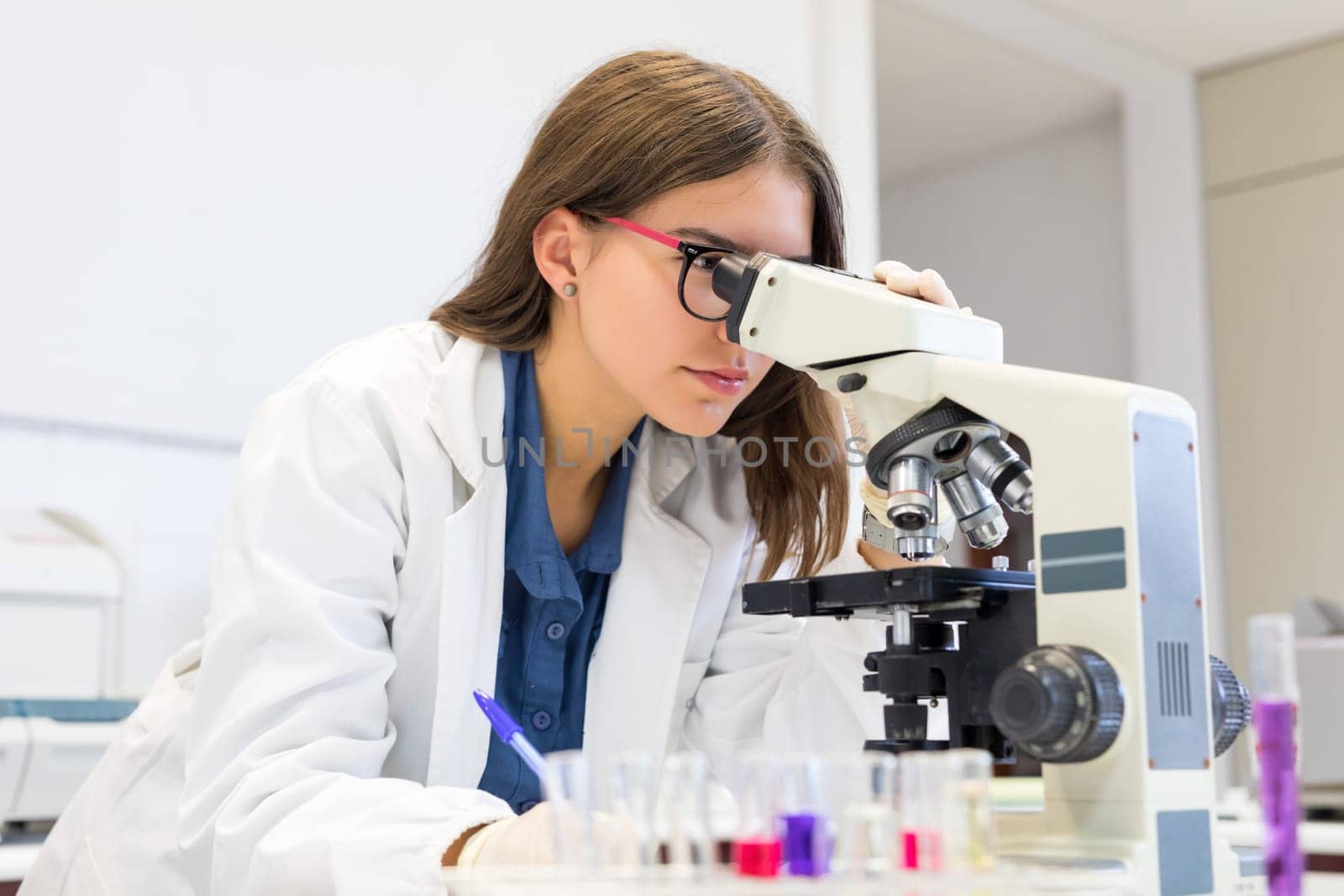 Beautiful young scientist working at the laboratory