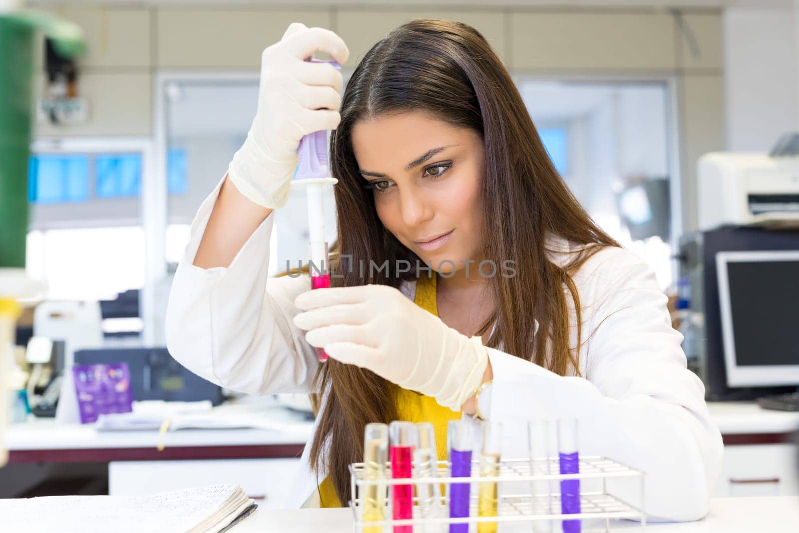 Beautiful young scientist working at the laboratory