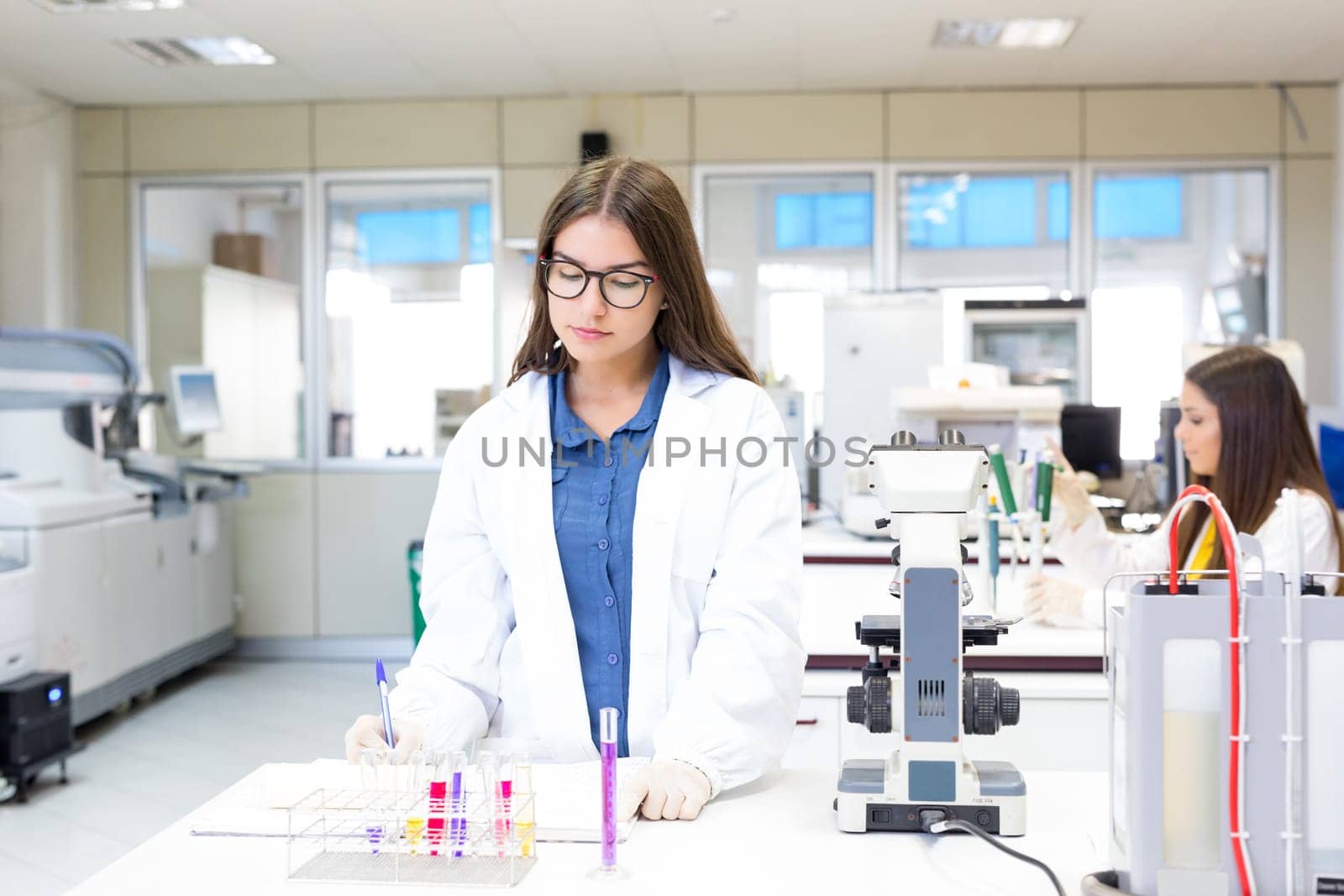 Beautiful young scientist working at the laboratory
