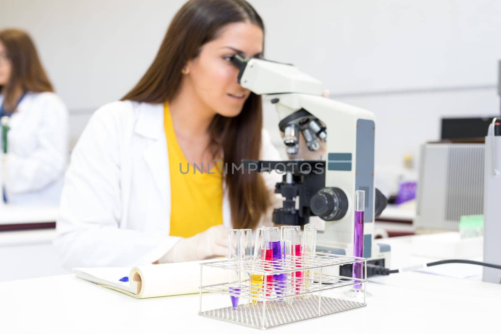 Beautiful young scientist working at the laboratory