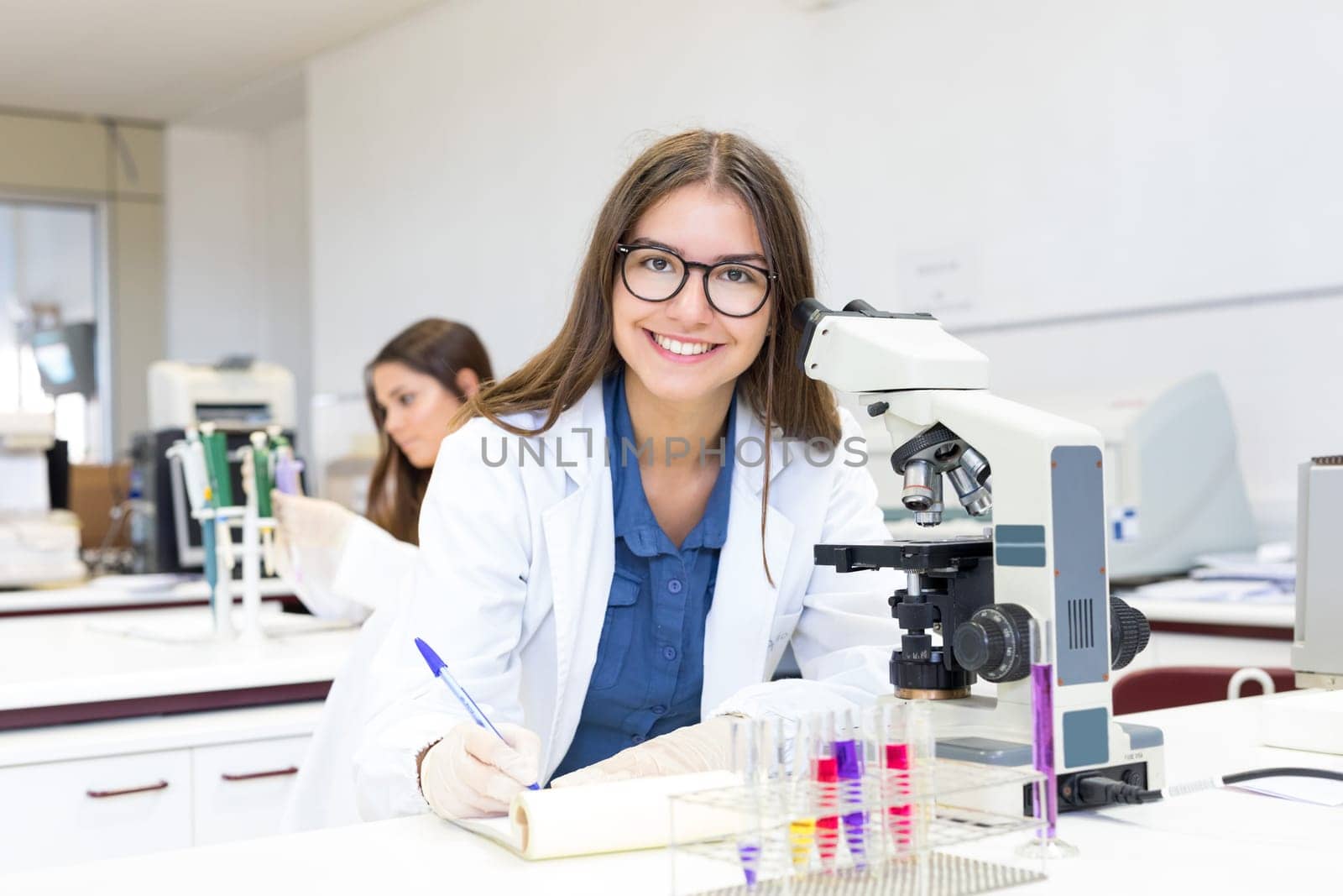 Beautiful young scientist working at the laboratory