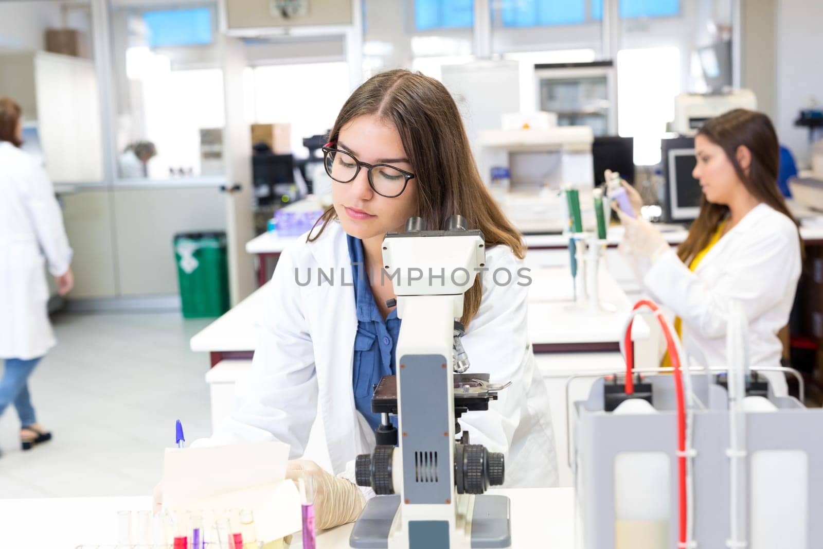 Beautiful young scientist working at the laboratory