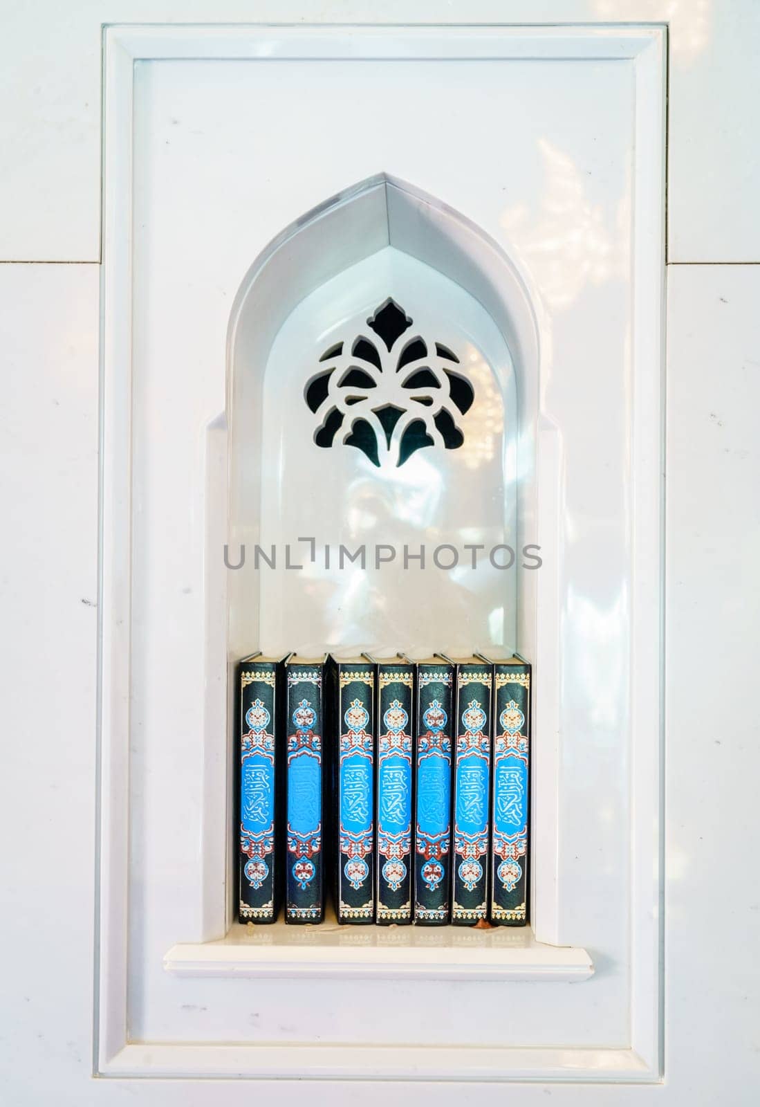 Sacred Quran books in an alcove at a mosque