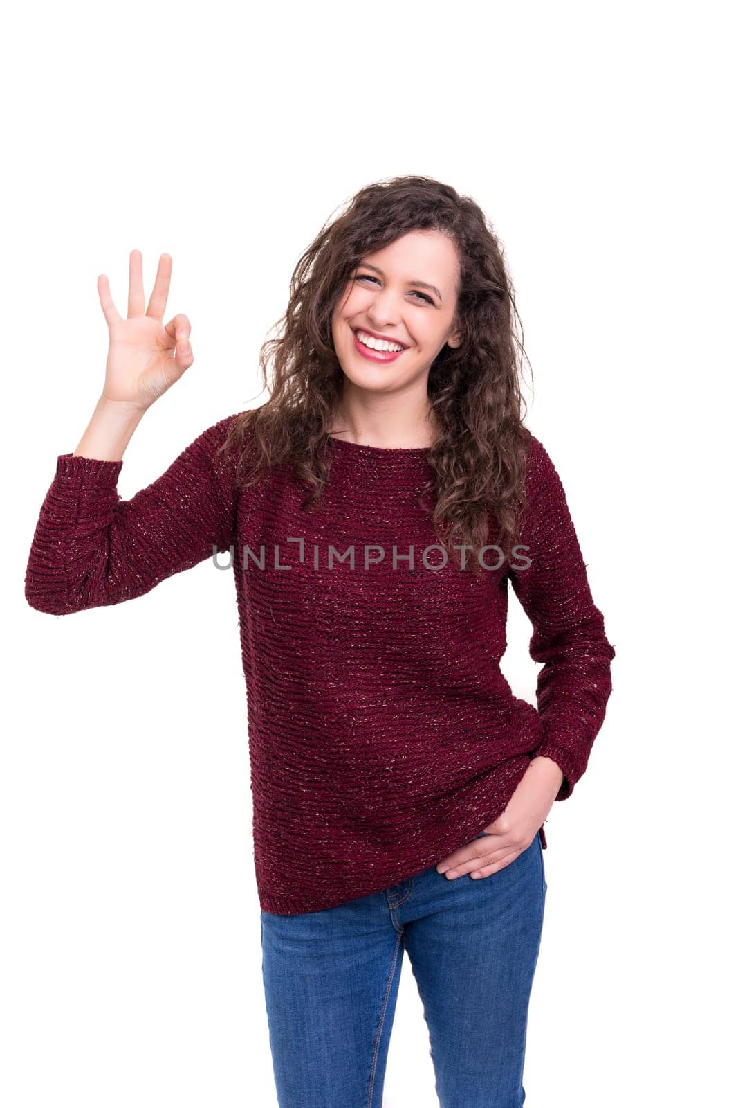 Beautiful young woman signaling ok, isolated over white