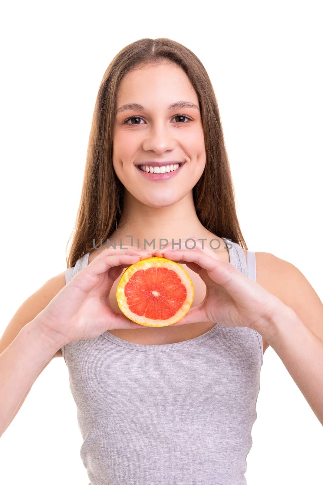 Young woman holding a fresh grapefruit, isolated over white background