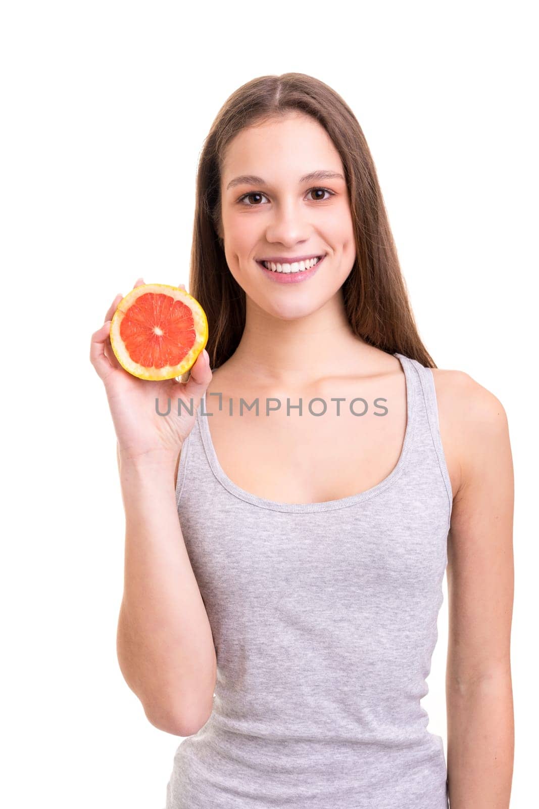 Young woman holding a fresh grapefruit, isolated over white background