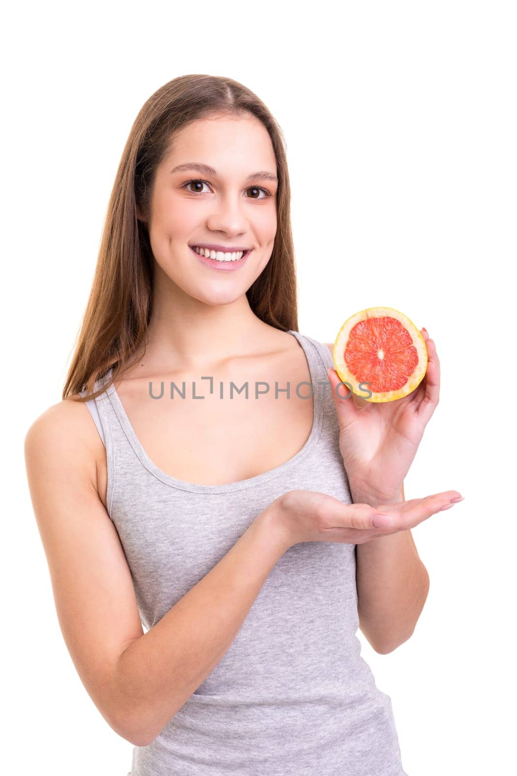 Young woman holding a fresh grapefruit, isolated over white background
