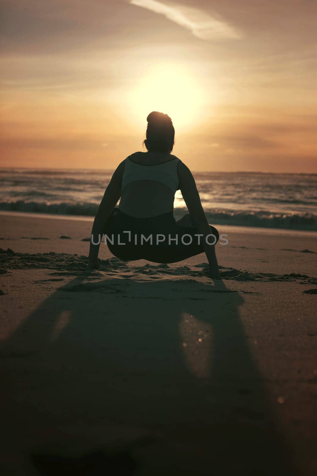Sporty young woman doing yoga practice at the beach - concept of healthy life and natural balance between body and mental development