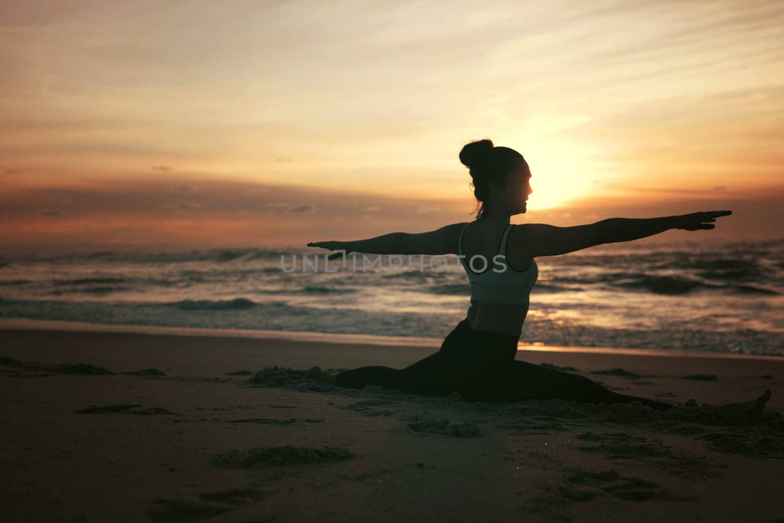 Sporty young woman doing yoga practice at the beach - concept of healthy life and natural balance between body and mental development