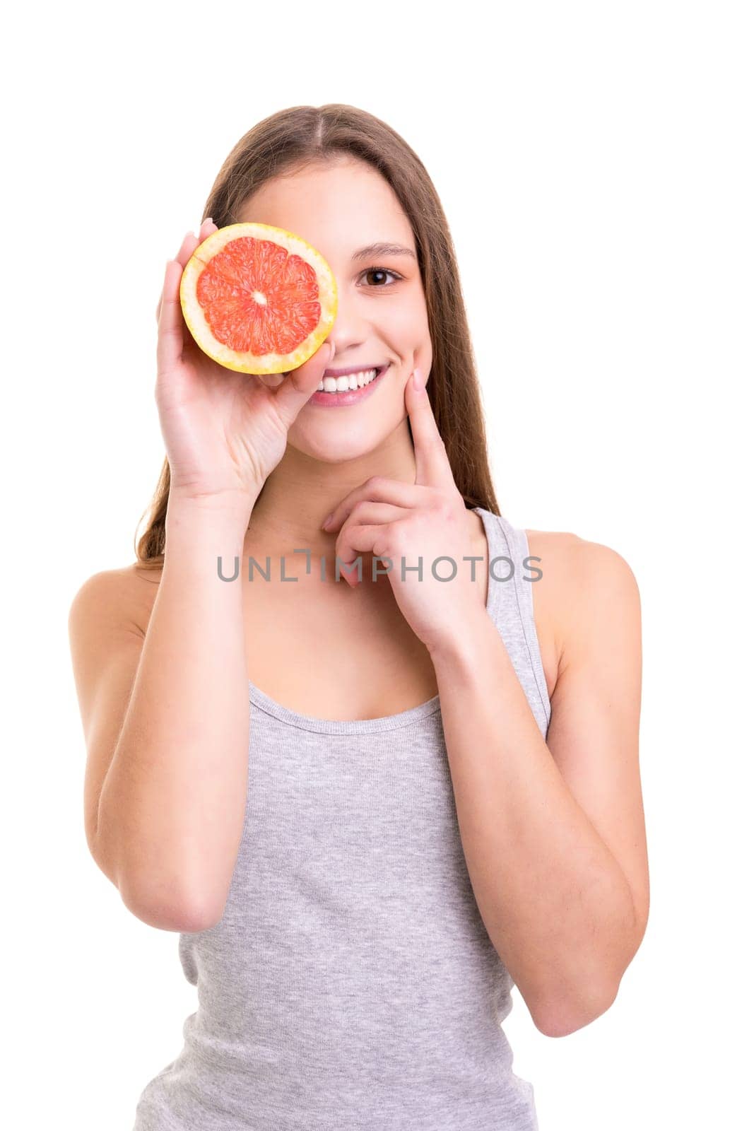 Young woman holding a fresh grapefruit, isolated over white background