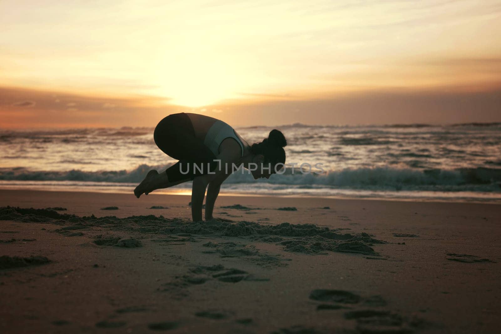 Sporty young woman doing yoga practice at the beach - concept of healthy life and natural balance between body and mental development