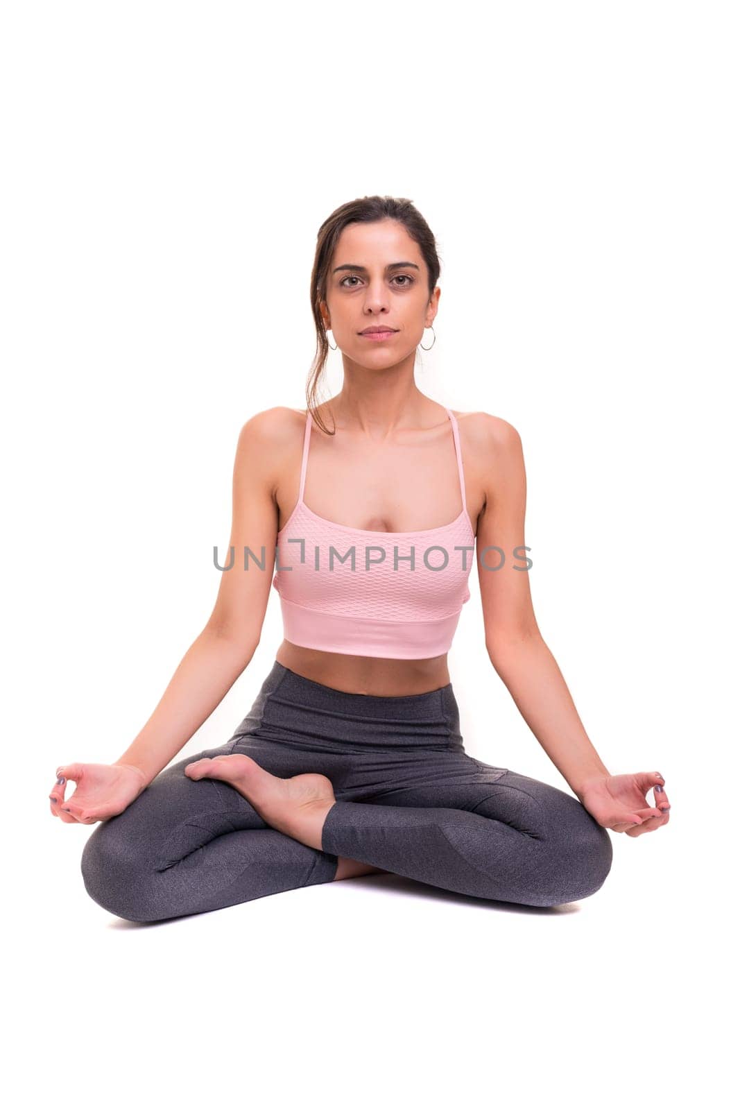 Sporty young woman doing yoga practice isolated on white background - concept of healthy life and natural balance between body and mental development