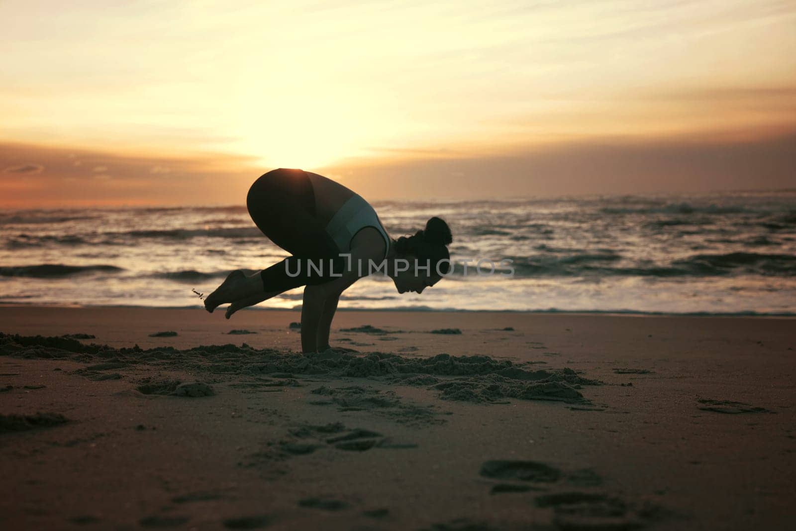 Sporty young woman doing yoga practice at the beach - concept of healthy life and natural balance between body and mental development