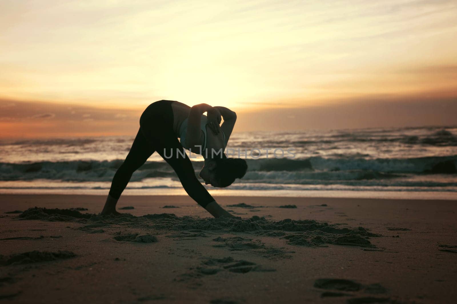 Sporty young woman doing yoga practice at the beach - concept of healthy life and natural balance between body and mental development