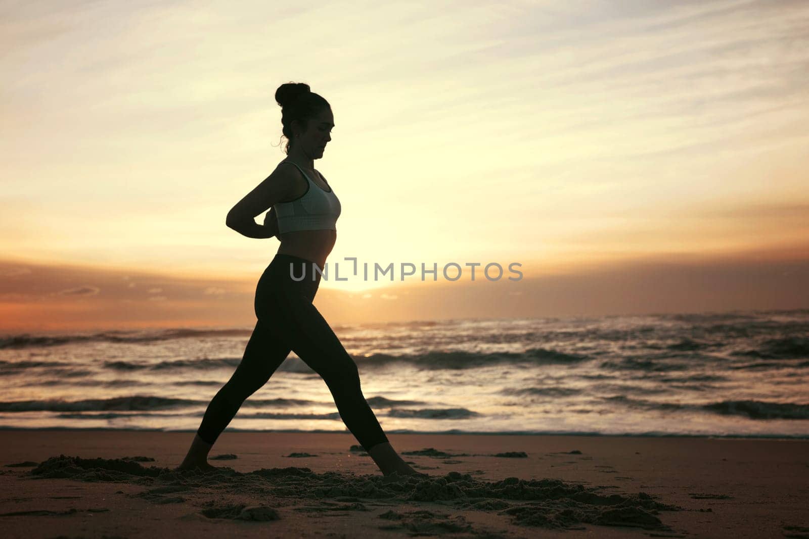 Sporty young woman doing yoga practice at the beach - concept of healthy life and natural balance between body and mental development