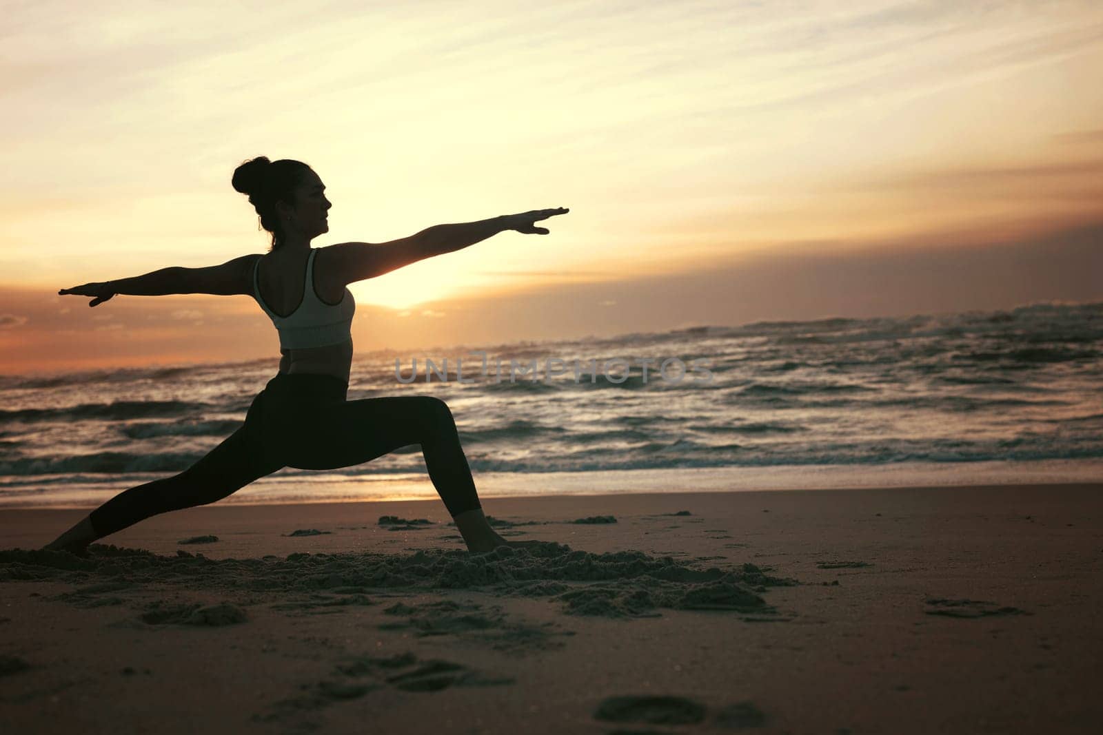 Sporty young woman doing yoga practice at the beach - concept of healthy life and natural balance between body and mental development